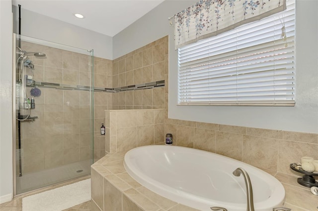 bathroom featuring tile patterned floors and separate shower and tub