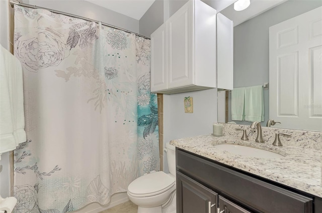 bathroom with curtained shower, vanity, and toilet