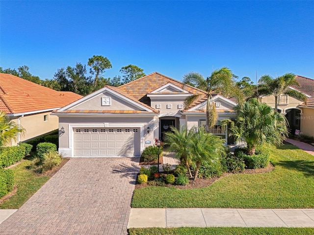 view of front of property with a garage and a front yard