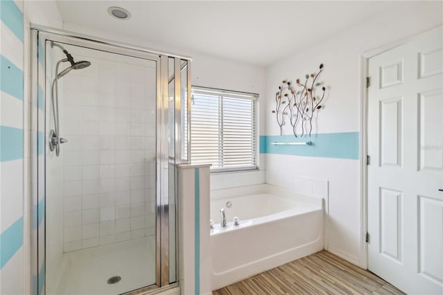 bathroom featuring shower with separate bathtub