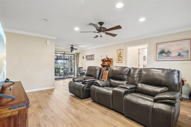 cinema room featuring ceiling fan, light hardwood / wood-style flooring, and crown molding