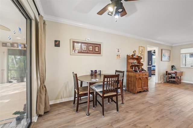 dining space with ceiling fan, ornamental molding, and light wood-type flooring