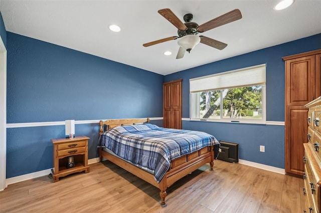 bedroom featuring ceiling fan and light hardwood / wood-style flooring