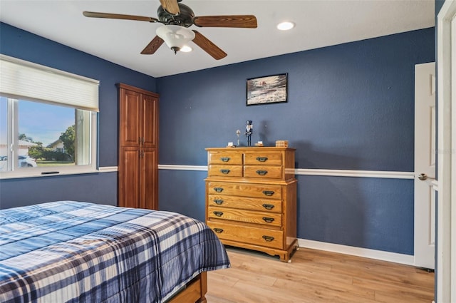 bedroom featuring ceiling fan and light hardwood / wood-style flooring