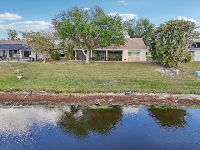 rear view of property with a water view