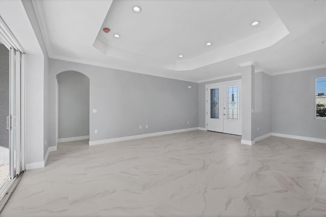 empty room featuring french doors, crown molding, and a tray ceiling