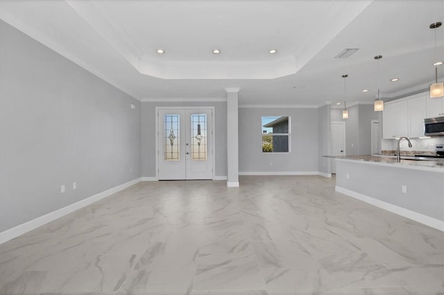 unfurnished living room with french doors, a raised ceiling, and crown molding