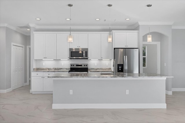 kitchen with appliances with stainless steel finishes, a center island with sink, and white cabinetry