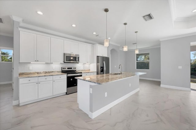 kitchen with white cabinets, an island with sink, and appliances with stainless steel finishes