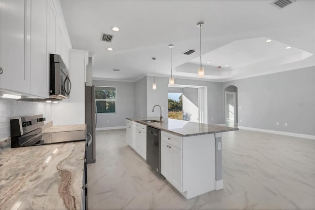 kitchen with white cabinetry, sink, pendant lighting, a kitchen island with sink, and appliances with stainless steel finishes