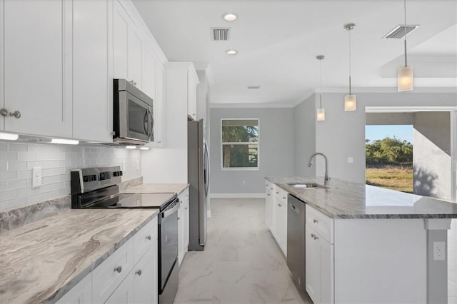 kitchen with pendant lighting, white cabinetry, sink, and stainless steel appliances