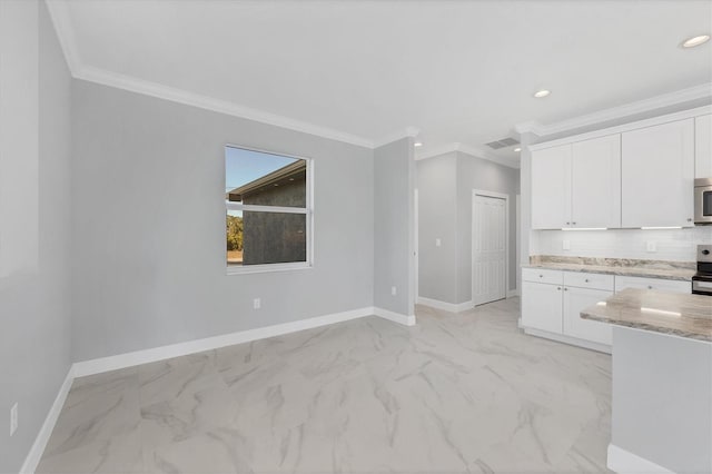 kitchen featuring appliances with stainless steel finishes, white cabinetry, and crown molding