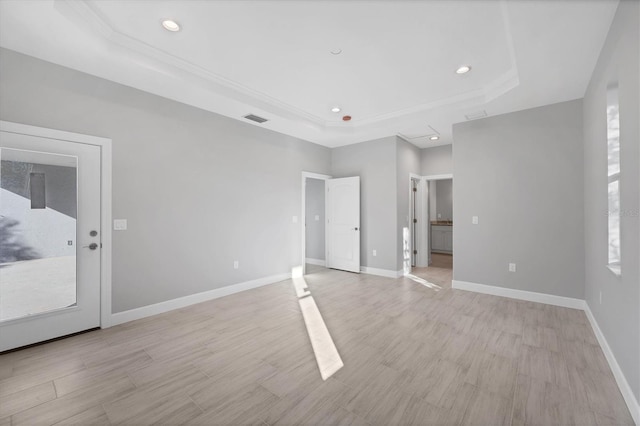 unfurnished room with a raised ceiling