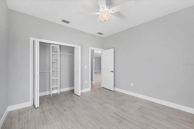 unfurnished bedroom with ceiling fan and a closet