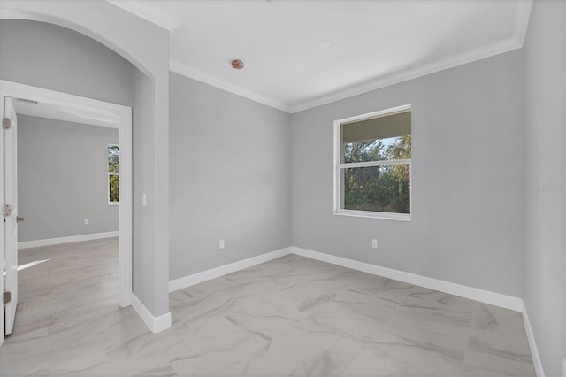 spare room with crown molding