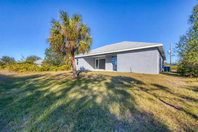 back of property featuring a lawn