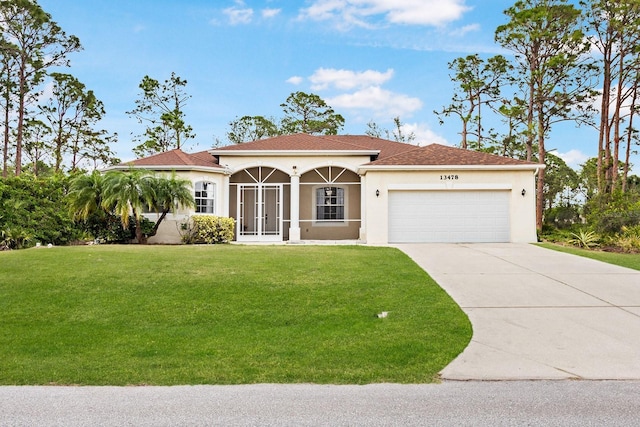 mediterranean / spanish home with french doors, a front lawn, and a garage