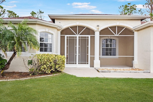 entrance to property featuring a yard