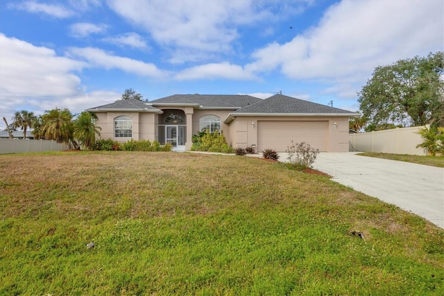 view of front of property featuring a garage and a front lawn