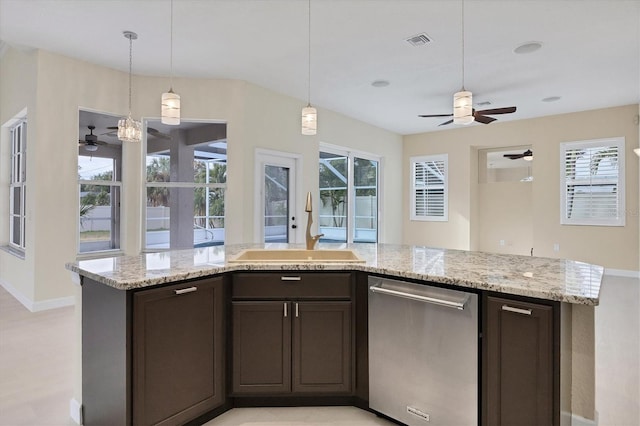 kitchen with a wealth of natural light, dark brown cabinets, sink, dishwasher, and hanging light fixtures