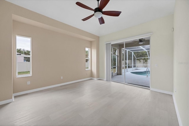 unfurnished room featuring light wood-type flooring and a wealth of natural light