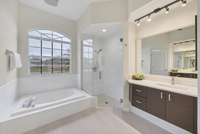 bathroom featuring plus walk in shower and vanity