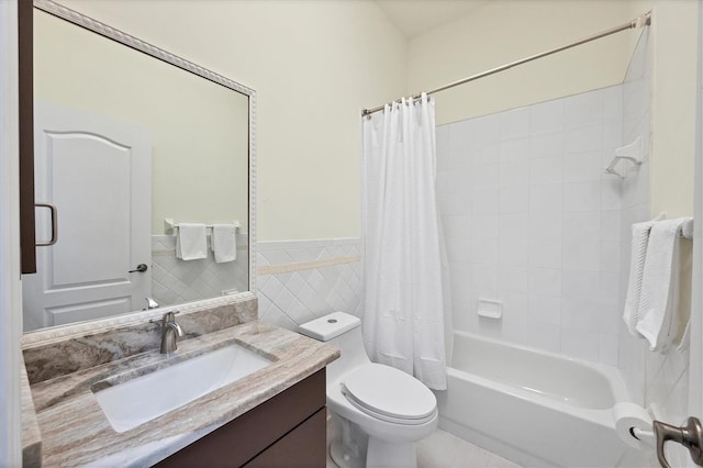 full bathroom with shower / bath combo with shower curtain, vanity, tile walls, and toilet