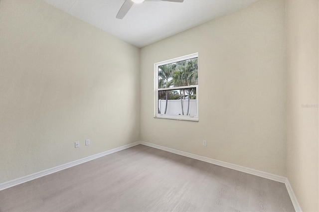 empty room with ceiling fan and light hardwood / wood-style floors