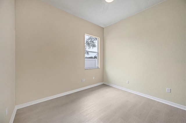 spare room featuring ceiling fan and light hardwood / wood-style flooring