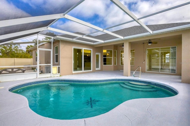 view of pool with a lanai, ceiling fan, and a patio