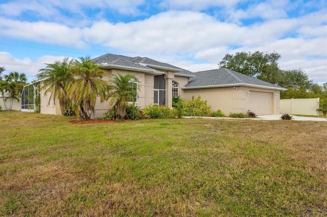 view of front of house with a garage and a front lawn