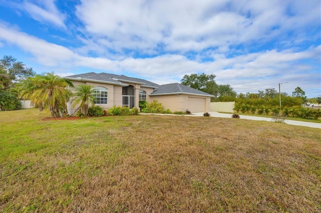 ranch-style house featuring a front lawn and a garage