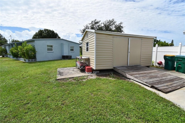 view of outdoor structure with a yard and cooling unit