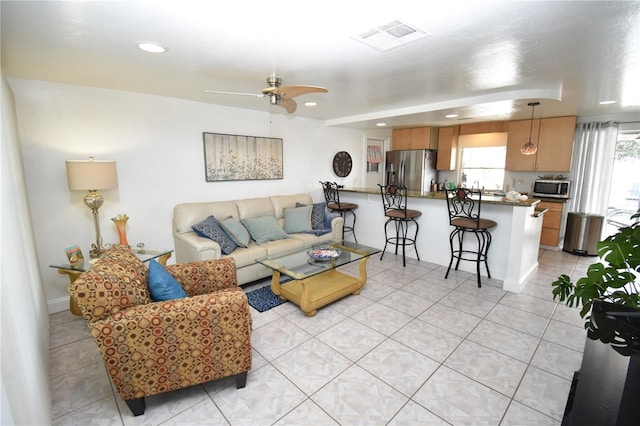 tiled living room featuring ceiling fan