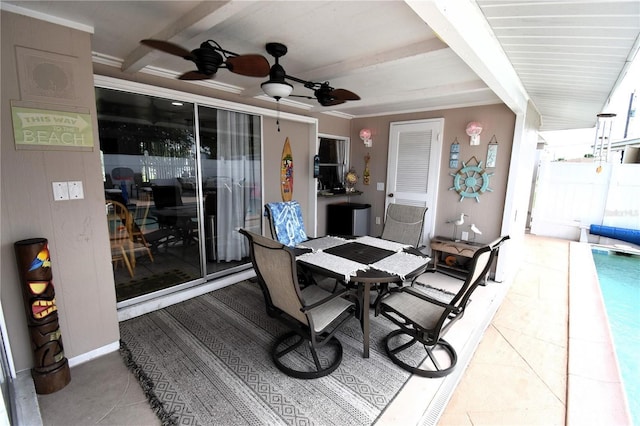 dining room with beam ceiling and ceiling fan