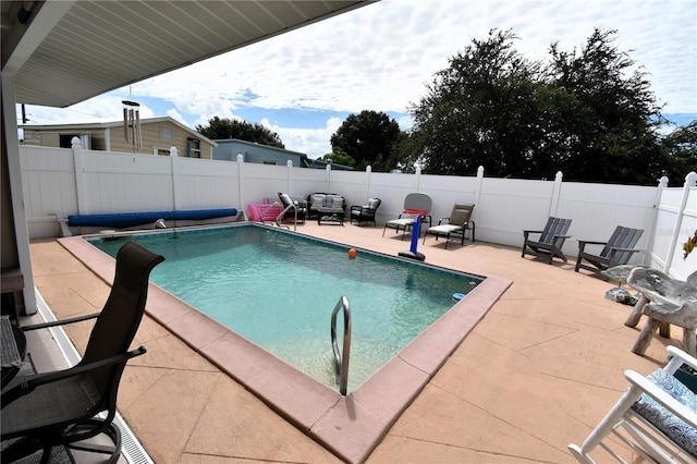 view of swimming pool featuring a patio area