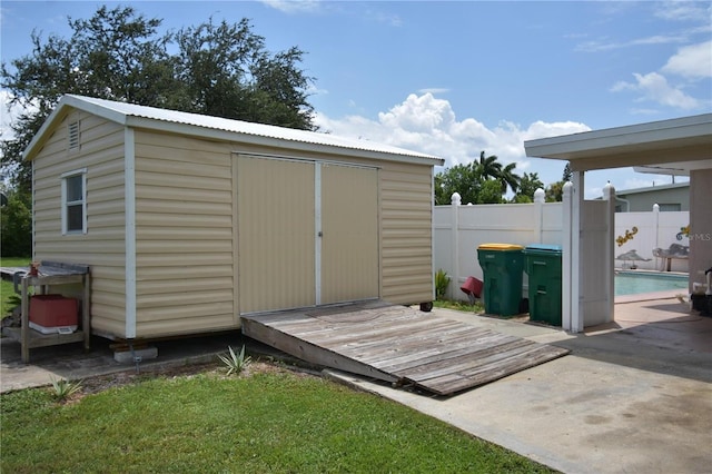 view of outbuilding featuring a fenced in pool