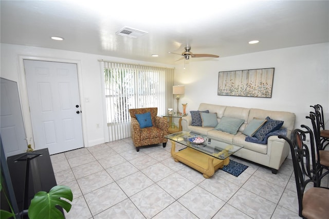 tiled living room featuring ceiling fan