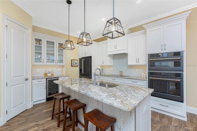 kitchen featuring wine cooler, white cabinetry, appliances with stainless steel finishes, and tasteful backsplash