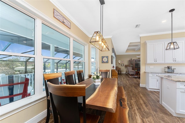 dining area featuring crown molding and dark wood-type flooring