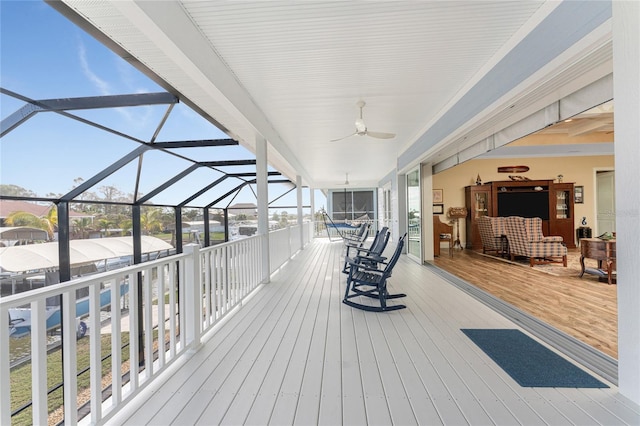 wooden deck featuring ceiling fan and a lanai