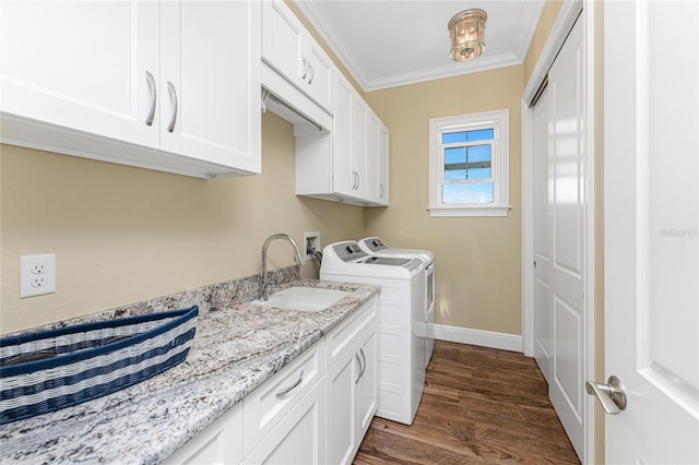 laundry area with sink, cabinets, washing machine and dryer, dark hardwood / wood-style flooring, and crown molding