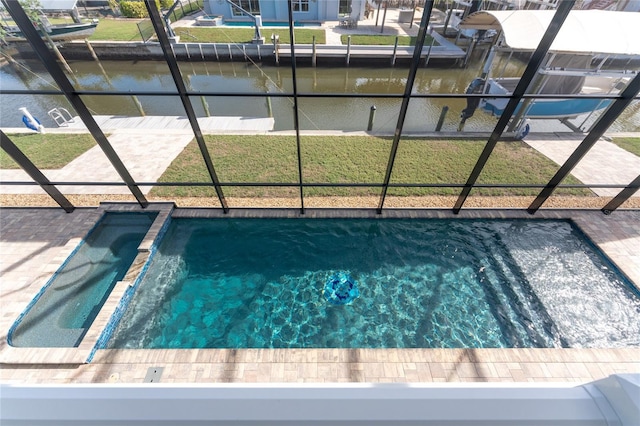 view of pool with a boat dock, a water view, and a lawn