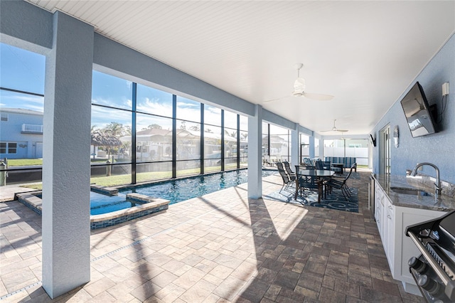 view of pool with ceiling fan and sink