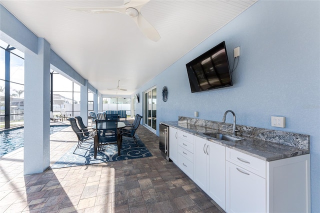 view of patio / terrace with ceiling fan and sink