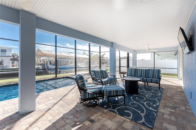 sunroom / solarium featuring ceiling fan