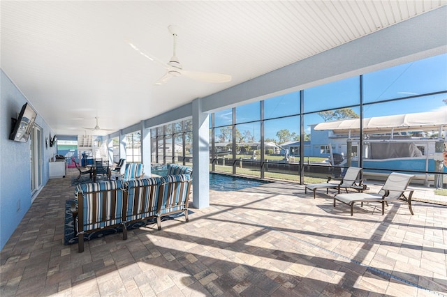 view of patio / terrace with ceiling fan and glass enclosure