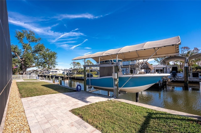 dock area featuring a lawn and a water view