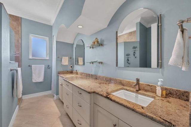 bathroom with tile patterned floors, crown molding, and vanity