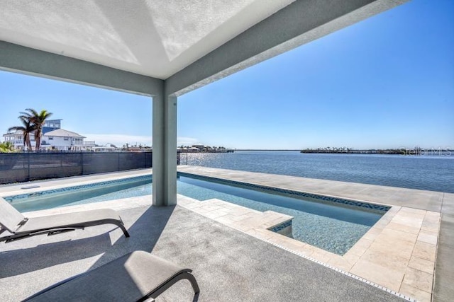 view of swimming pool with a water view and a patio